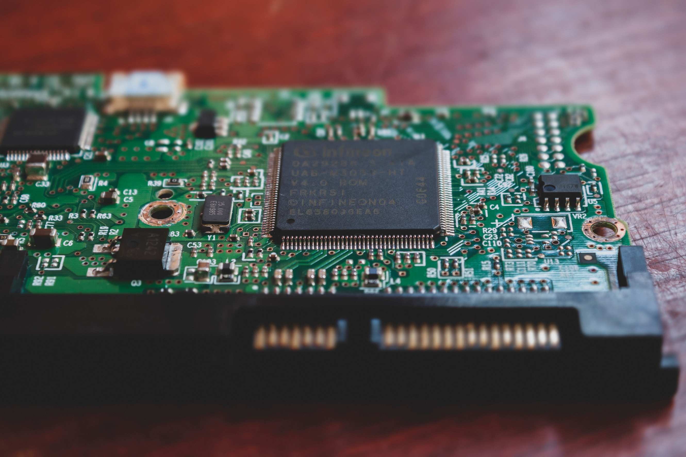 Close texture of electronic circuit board components, detailed close-up of a green electronic circuit board highlighting technology components